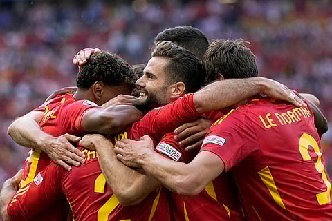 Spain players celebrate team's third goal
